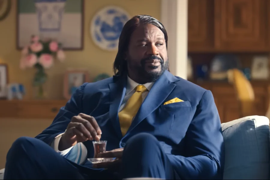 Shaquille O'Neal smiling with long hair and drinking Turkish tea in a viral commercial